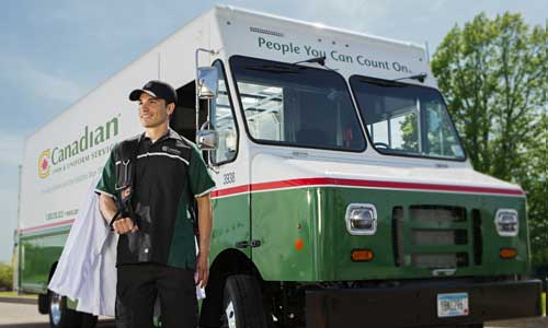Québec Linge truck with man delivering uniforms